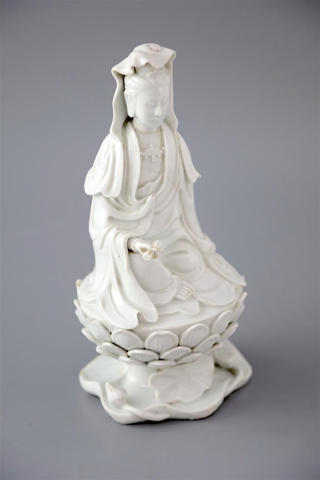 A Chinese Dehua blanc de chine seated figure of Guanyin, 18th/19th century, 25cm high